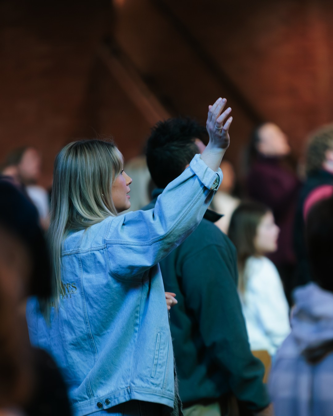 A woman worshiping during a Sunday service